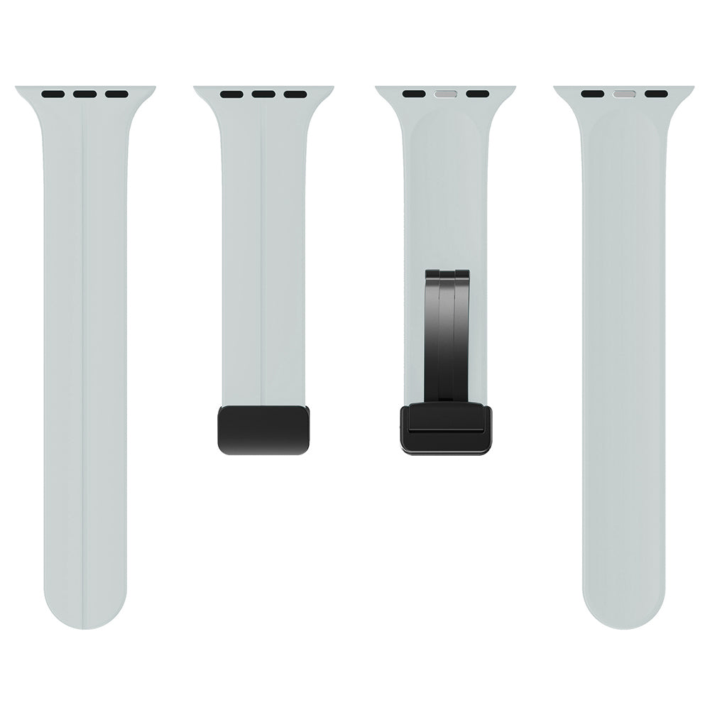 Pale gray silicone Apple Watch bands with magnetic deployant clasp shown in four variations, including solid band and metal buckle closure options