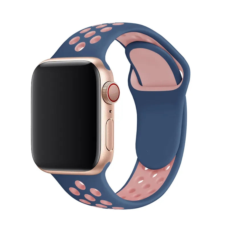 Gold Apple Watch with navy blue and rose pink perforated silicone sport band