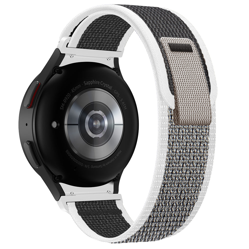 Black and grey smartwatch with sapphire crystal display and fabric loop band, showing GPS and heart rate monitoring features