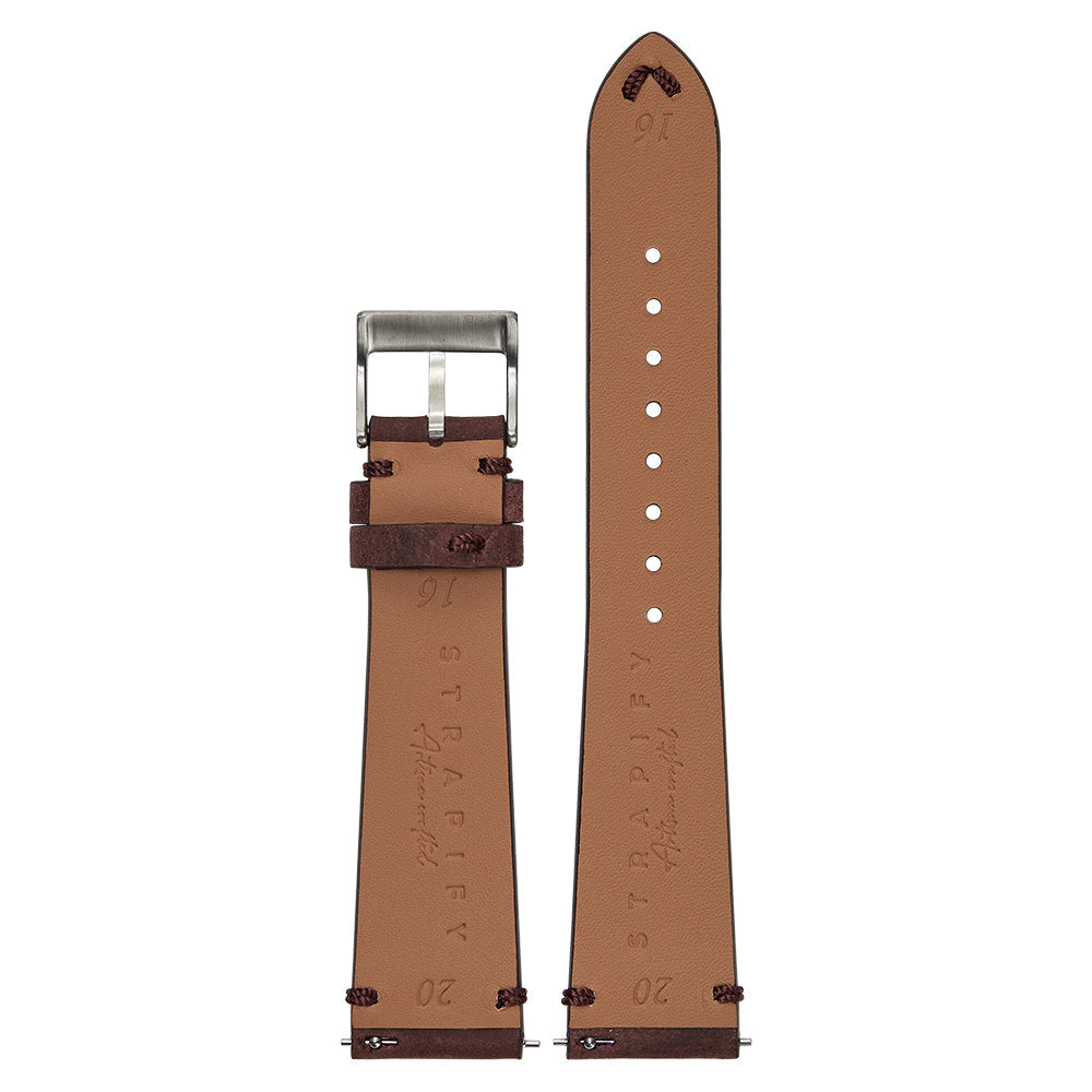 Tan leather quick release watch band with dark red accents, silver buckle, and adjustment holes displayed flat