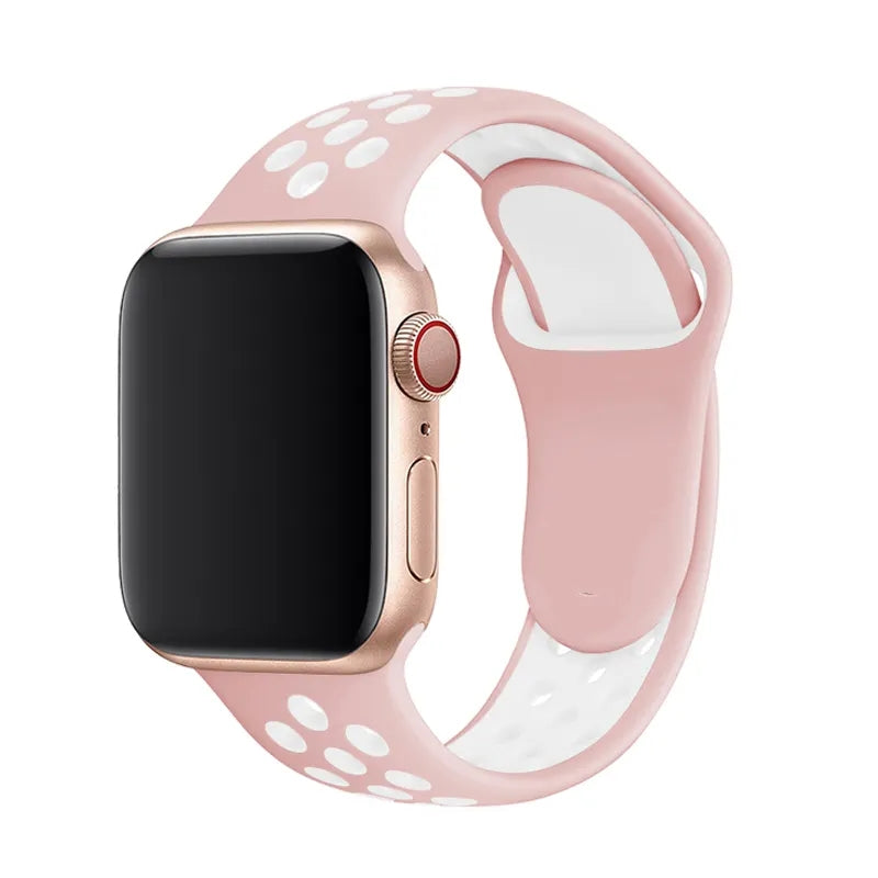 Rose gold smartwatch with pink and white perforated silicone sports band on white background
