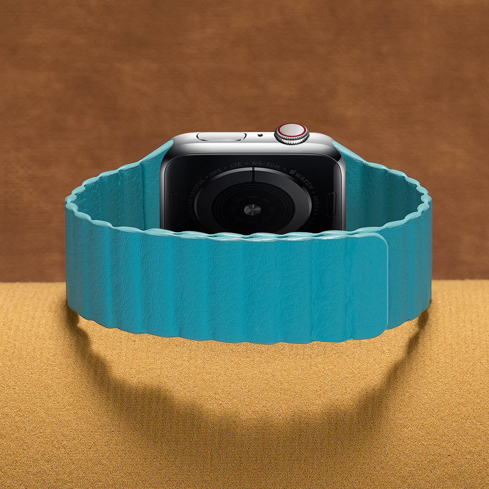 Turquoise leather loop band for smartwatch with silver case and digital crown on tan background