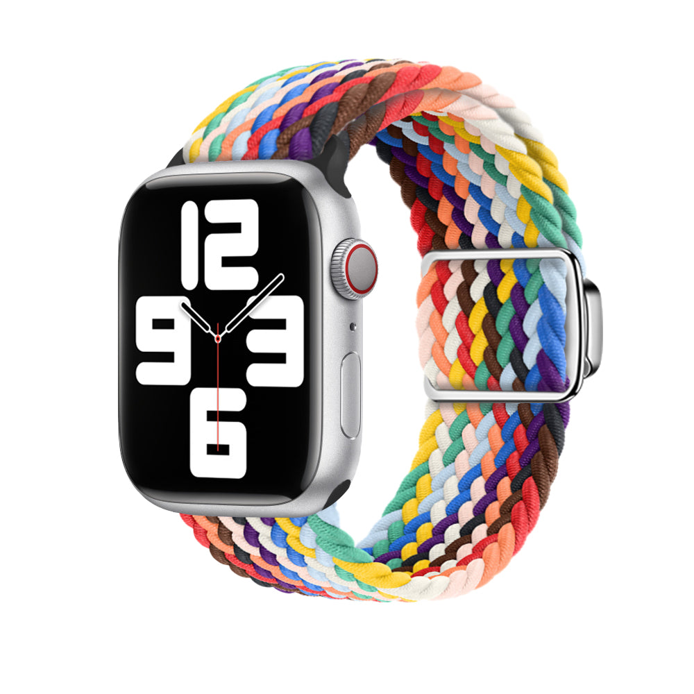 Silver aluminum Apple Watch with colorful braided fabric loop band featuring rainbow woven pattern and magnetic clasp closure