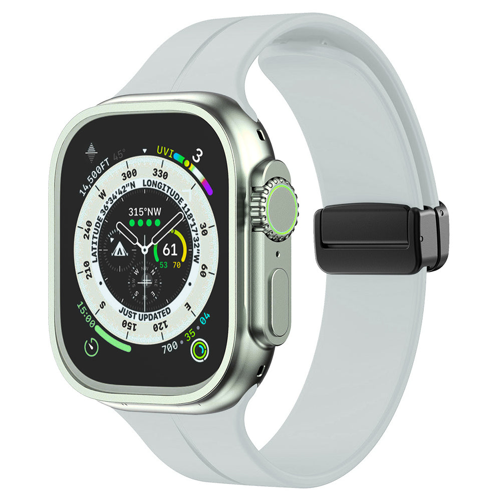Silver stainless steel smartwatch with white silicone band and magnetic clasp, displaying compass and fitness metrics on AMOLED screen