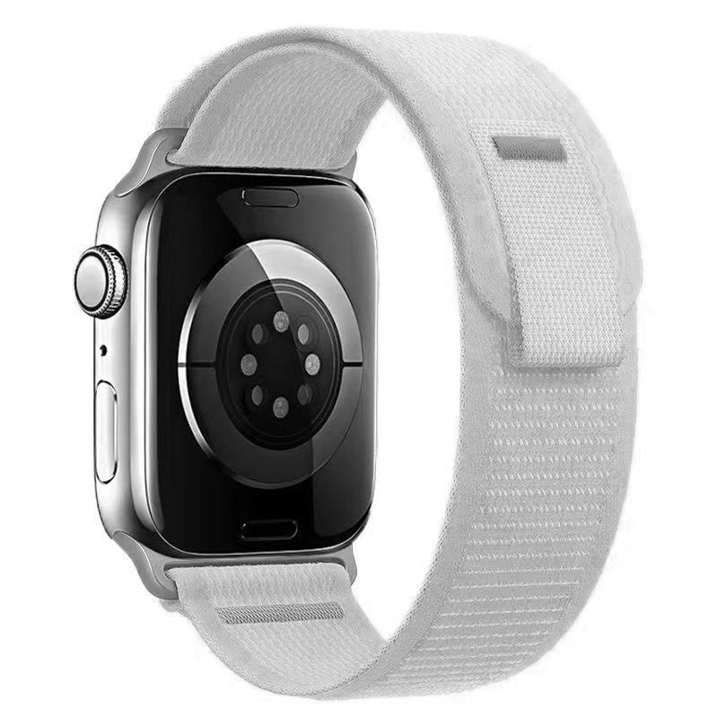 Silver aluminum Apple Watch with white textile Trail Loop band and digital crown, front view on white background