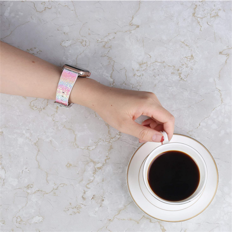 Woman wearing pink holographic glitter Apple Watch band with coffee cup on marble table