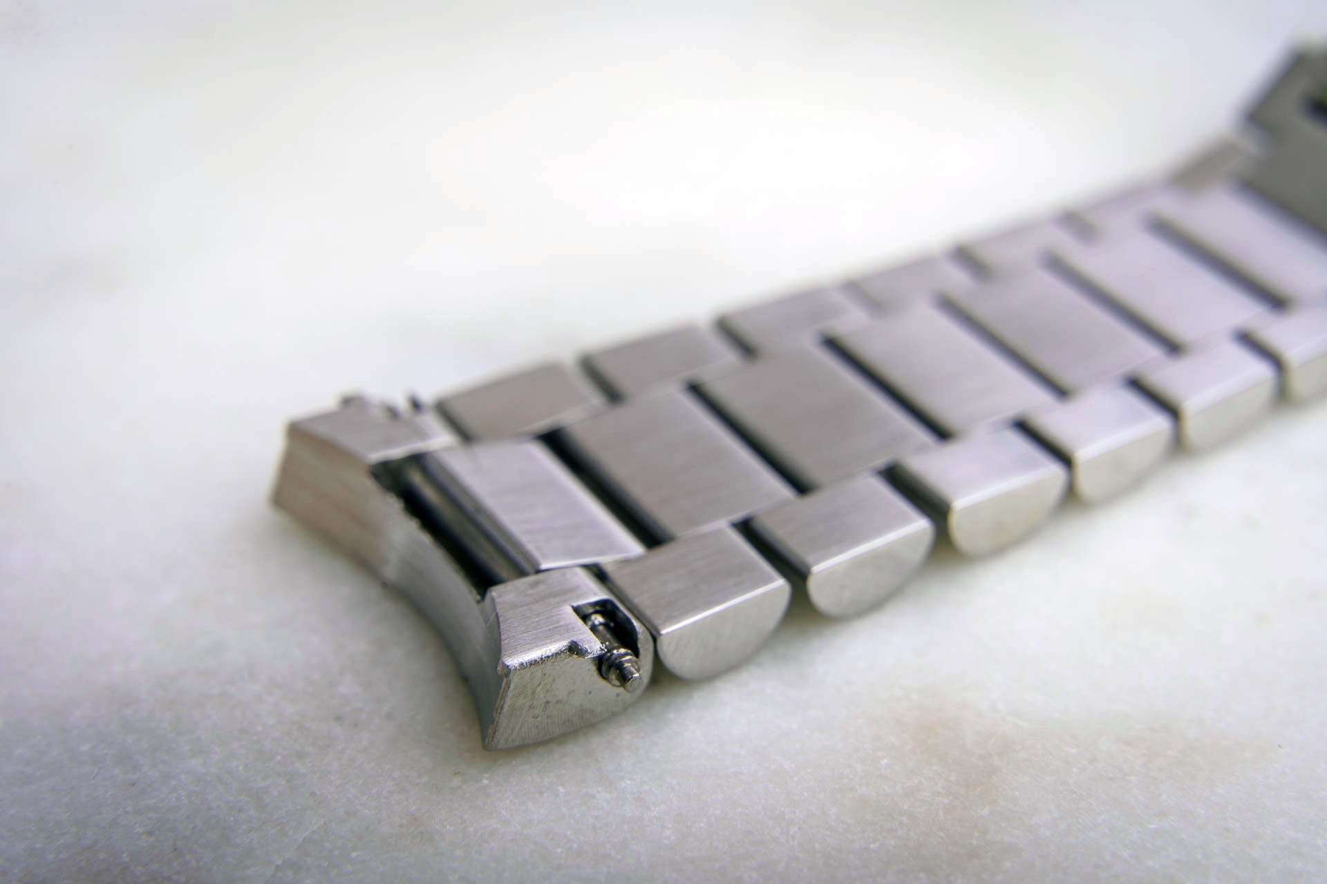 Stainless steel watch bracelet with solid links and end link for Omega Speedmaster 1861 caliber movement, polished metal finish