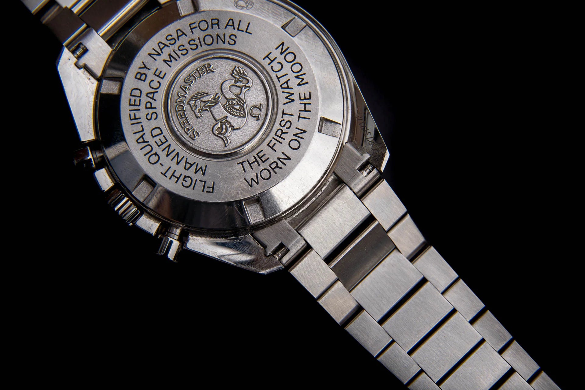 Silver stainless steel chronograph watch with engraved caseback featuring NASA space missions insignia and link bracelet
