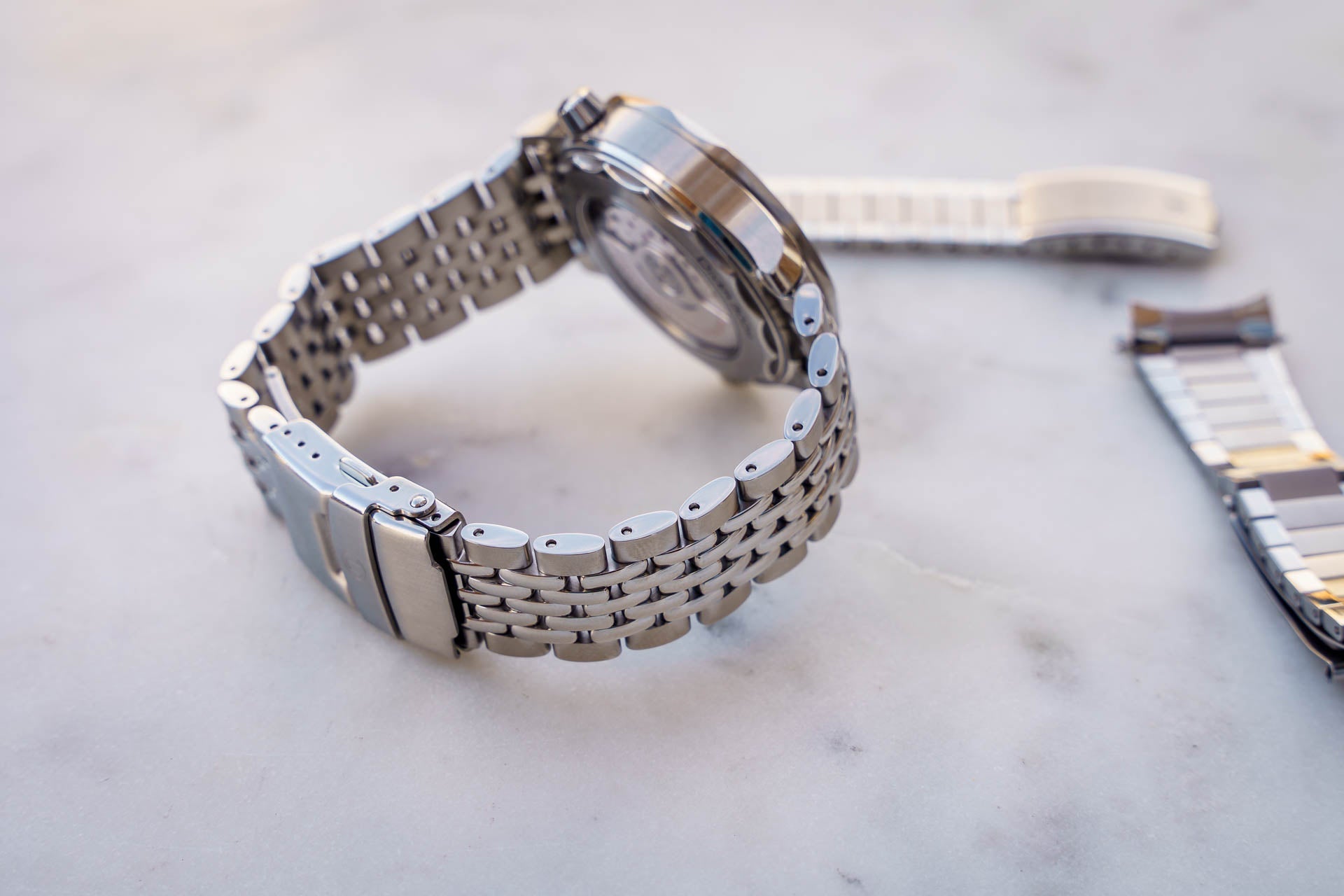 Stainless steel beads of rice bracelet for Omega Seamaster 300m watch with deployment clasp and extra links displayed