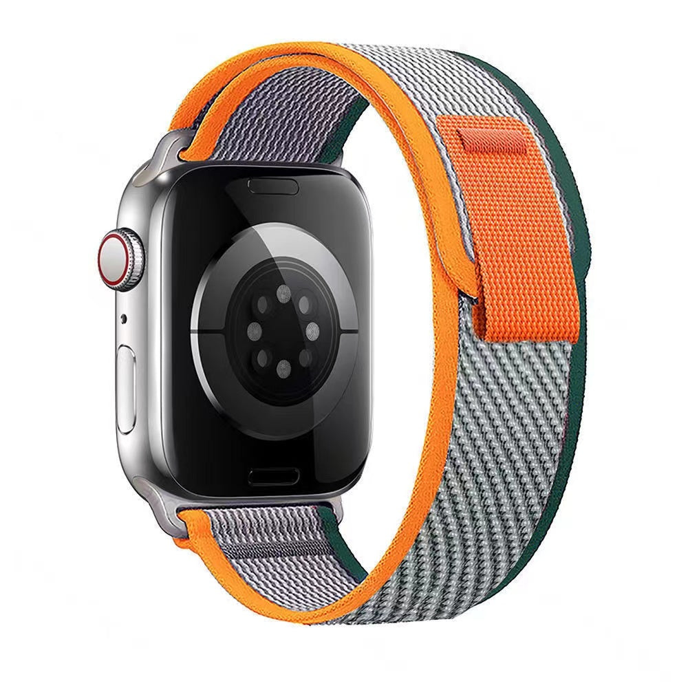 Stainless steel smartwatch with orange, gray and green woven Trail Loop band featuring yellow accent stripe