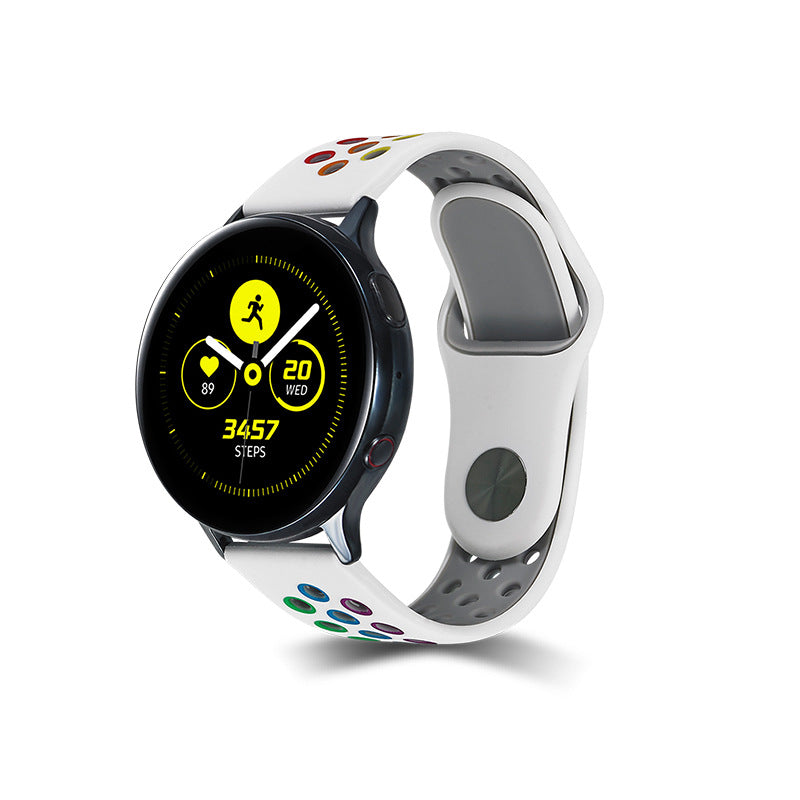 Black and white smartwatch with rainbow silicone sports band displaying fitness metrics and 3457 steps on AMOLED screen