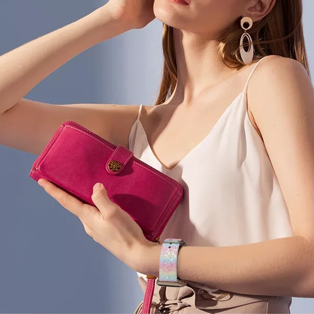 Woman wearing pink glitter Apple Watch band with matching fuchsia wallet and oval drop earrings