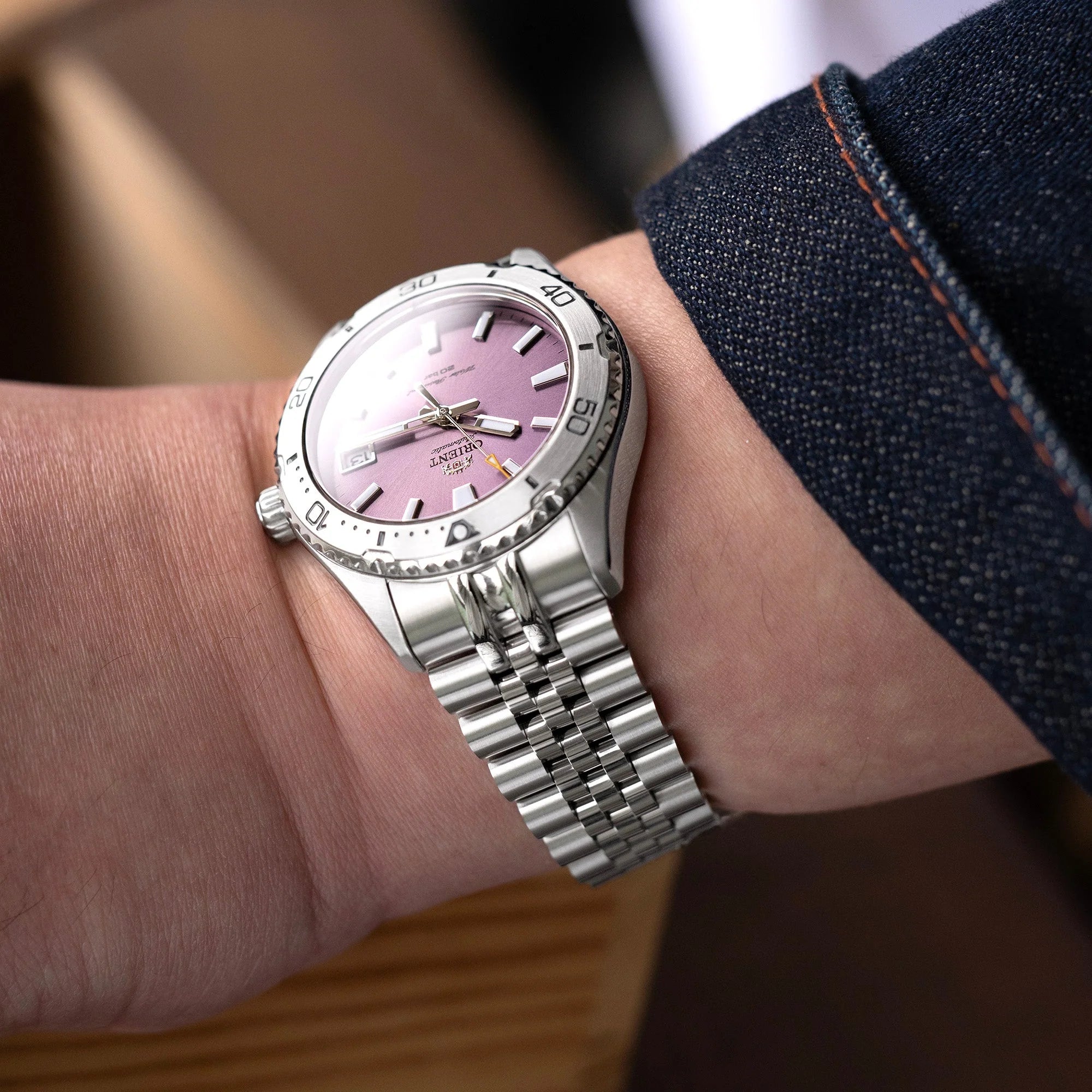 Stainless steel Super-JUB II watch band on Orient Mako 40 with pink dial and denim sleeve detail
