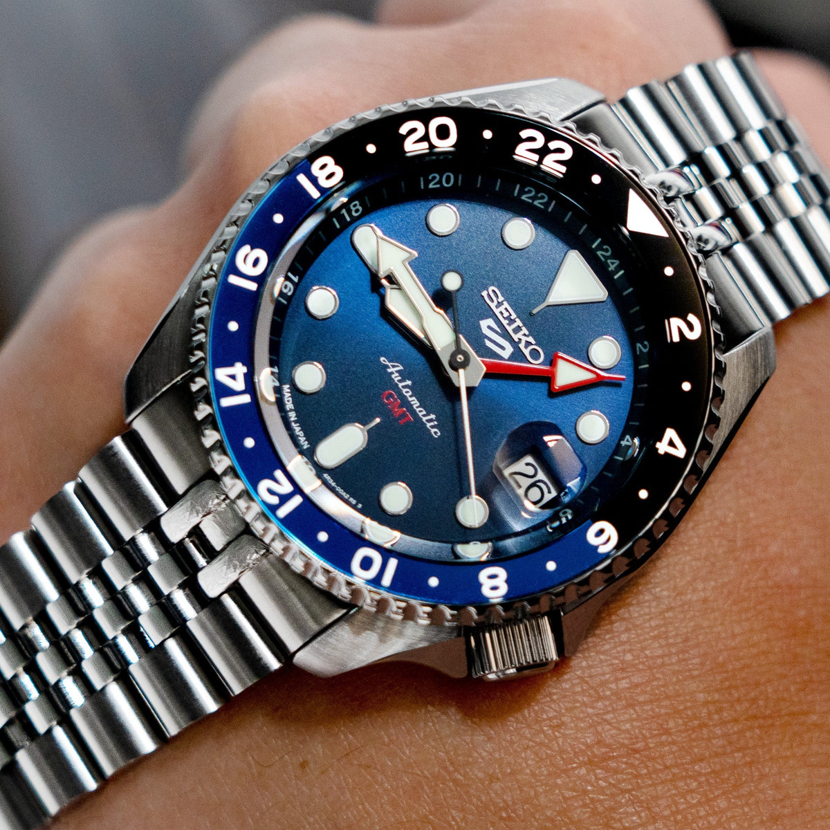 Seiko 5 GMT SSK001 dive watch with blue dial and black bezel on stainless steel Super-J Louis bracelet, worn on wrist