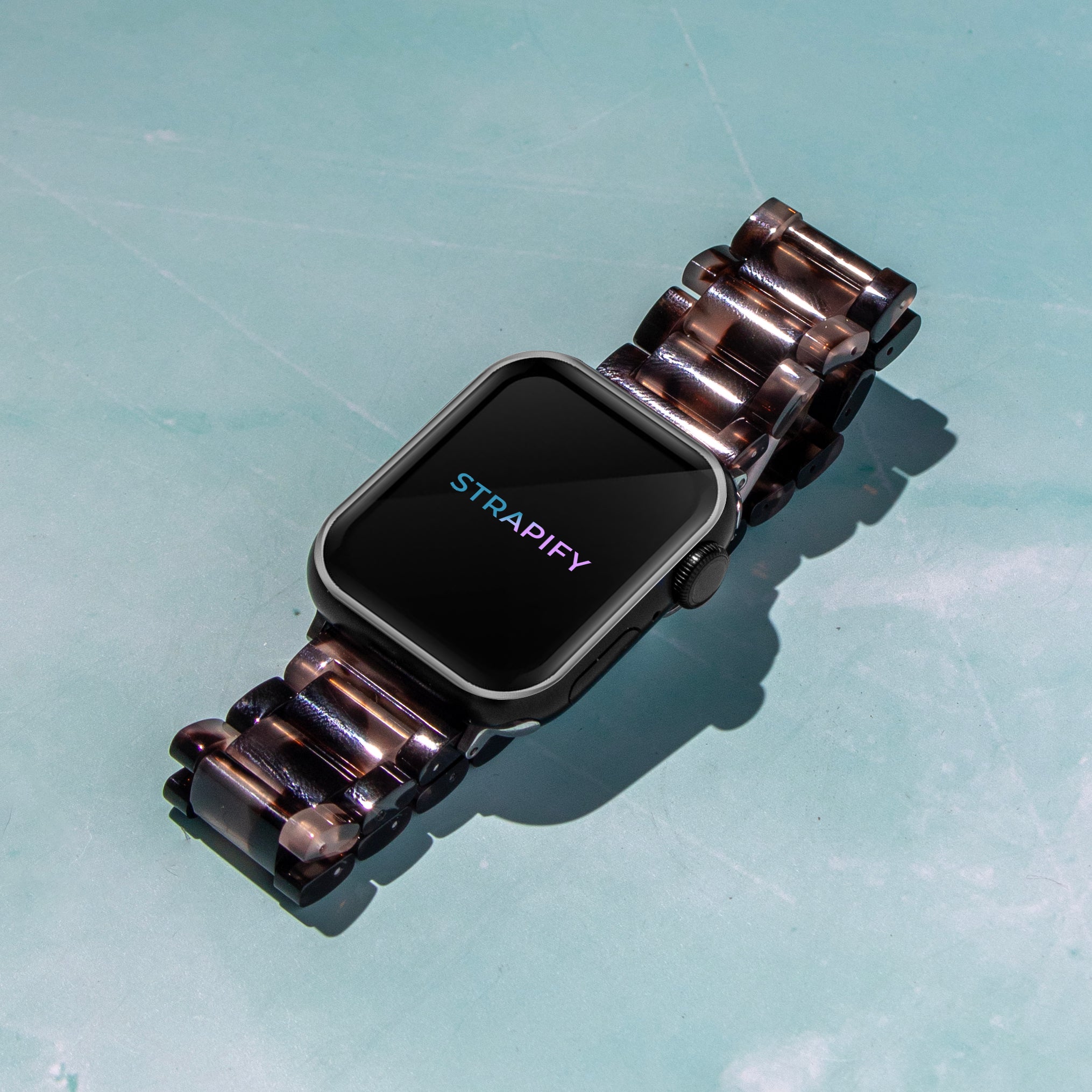 Strapify tortoiseshell dark brown crystallised acetate smartwatch band for Apple Watch on turquoise background