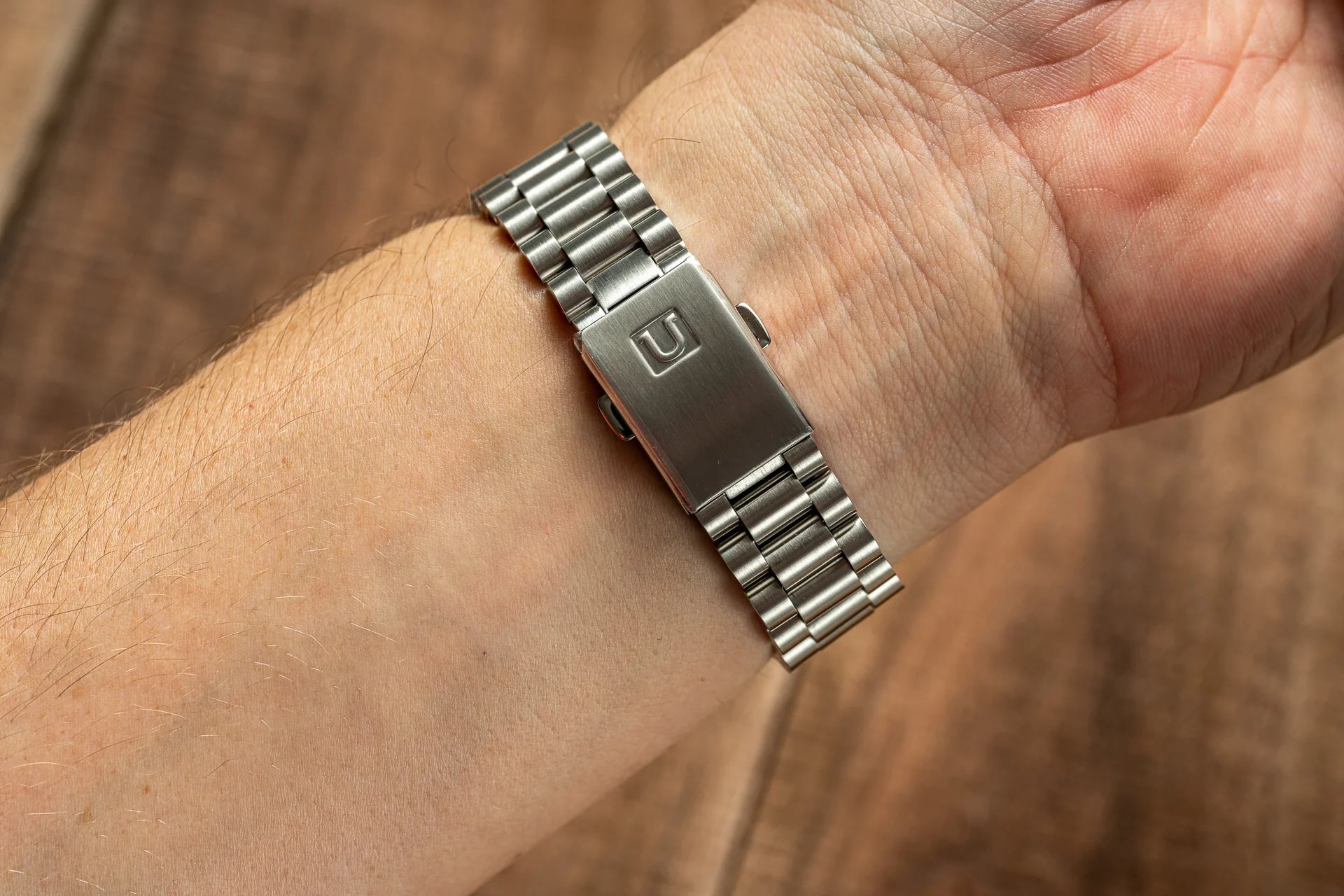 Stainless steel Uncle Lincoln bracelet with solid link design and integrated end links fitted on wrist, compatible with Seiko 19mm Alpinist watch