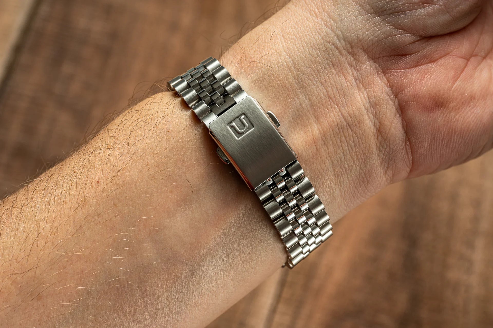 Stainless steel executive bracelet with solid links worn on wrist, compatible with Seiko 19mm Alpinist watch