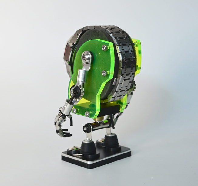 Neon green Minibot watch stand with articulated silver arms and black tank tread band on white base