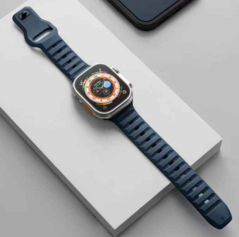 Stainless steel smartwatch with orange compass dial and navy blue ridged silicone sports band