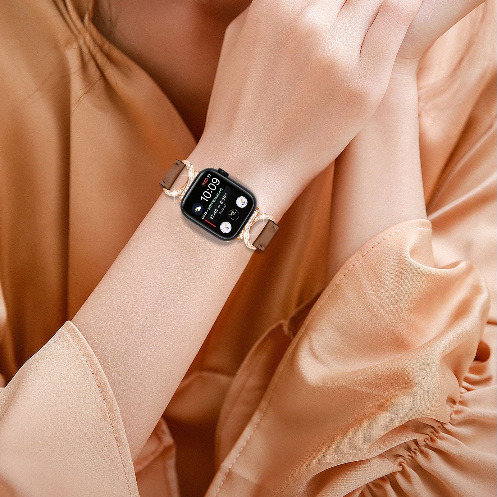 Woman wearing black smartwatch with rose gold Ava leather link band on wrist, displaying time 10:09