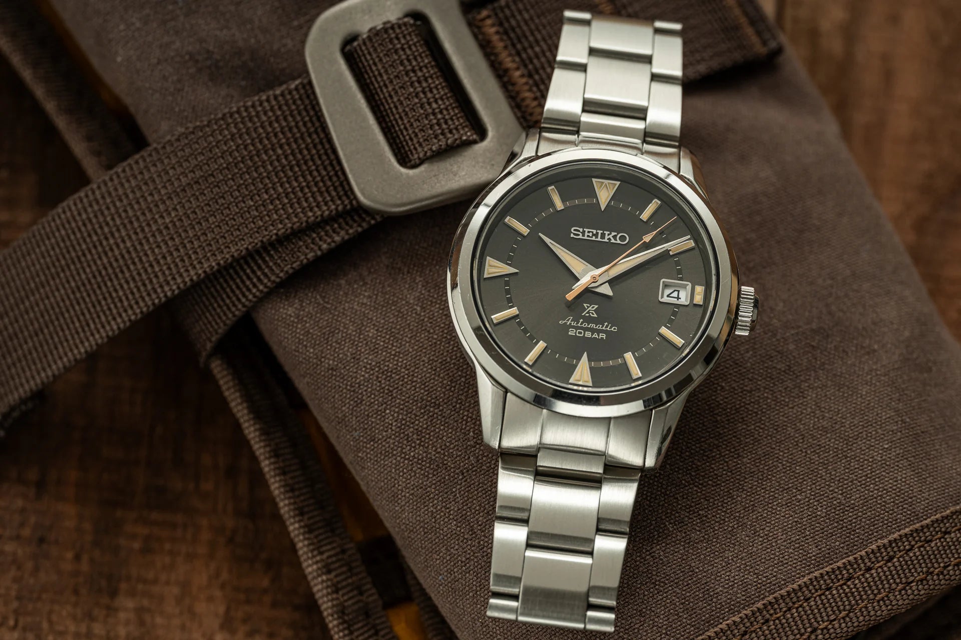 Seiko Prospex Alpinist automatic watch with stainless steel bracelet and black dial on brown canvas strap with buckle