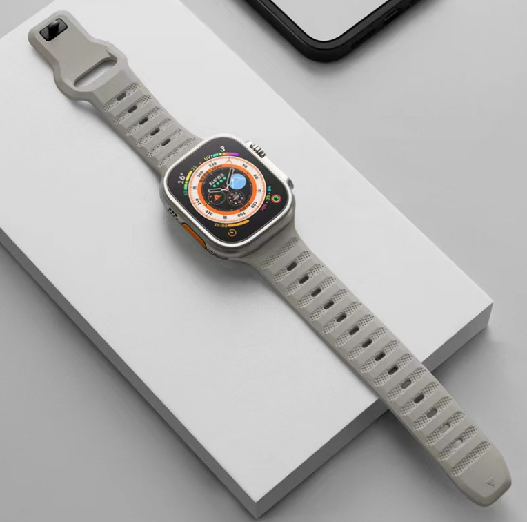Beige sports smartwatch with ridged rubber strap and digital display showing compass and weather information