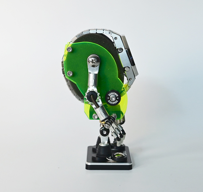 Neon green and black Minibot robotic watch stand with articulated arms and chrome details on display base