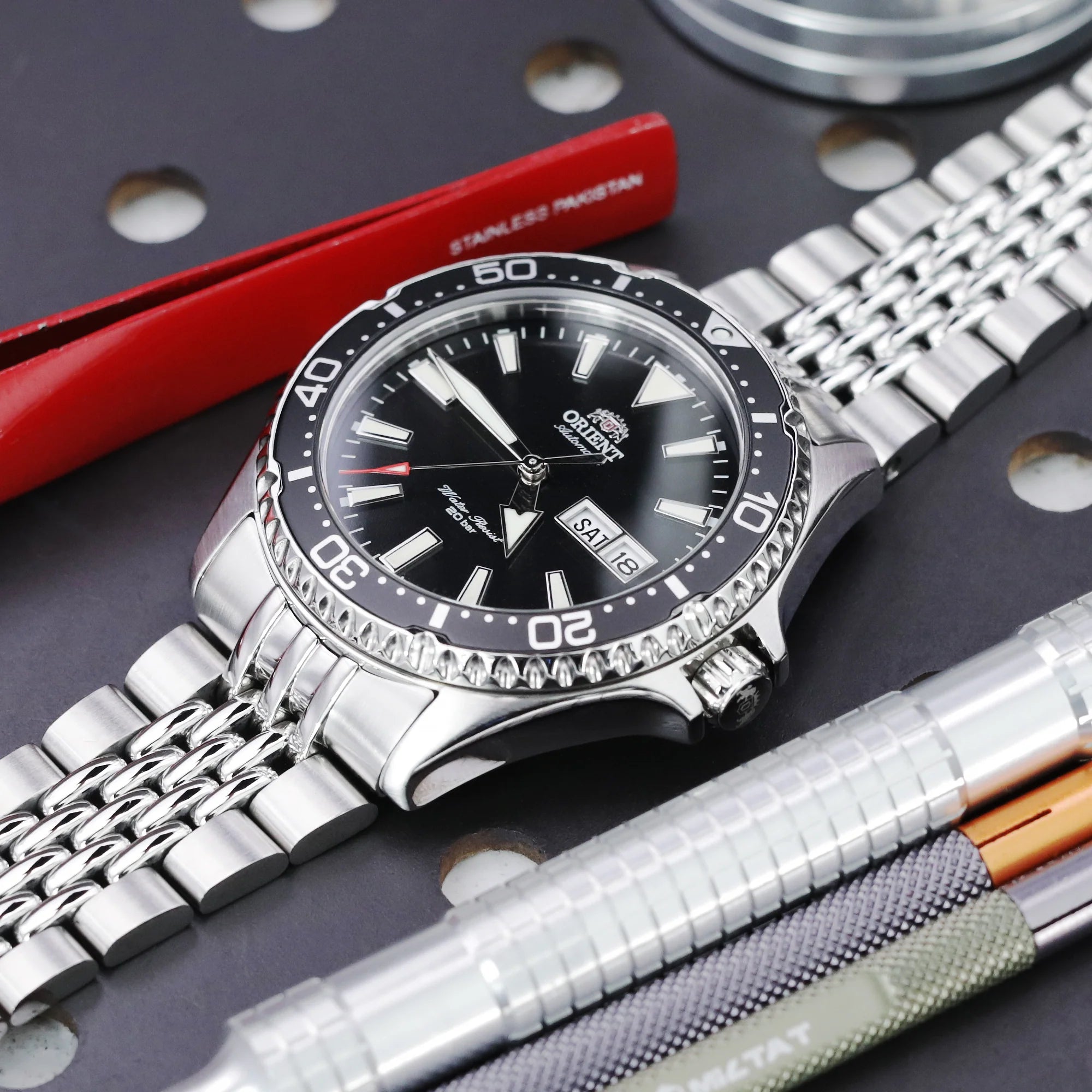 Strapcode Goma BOR stainless steel bracelet fitted on Orient Kamasu watch with black dial and day-date window