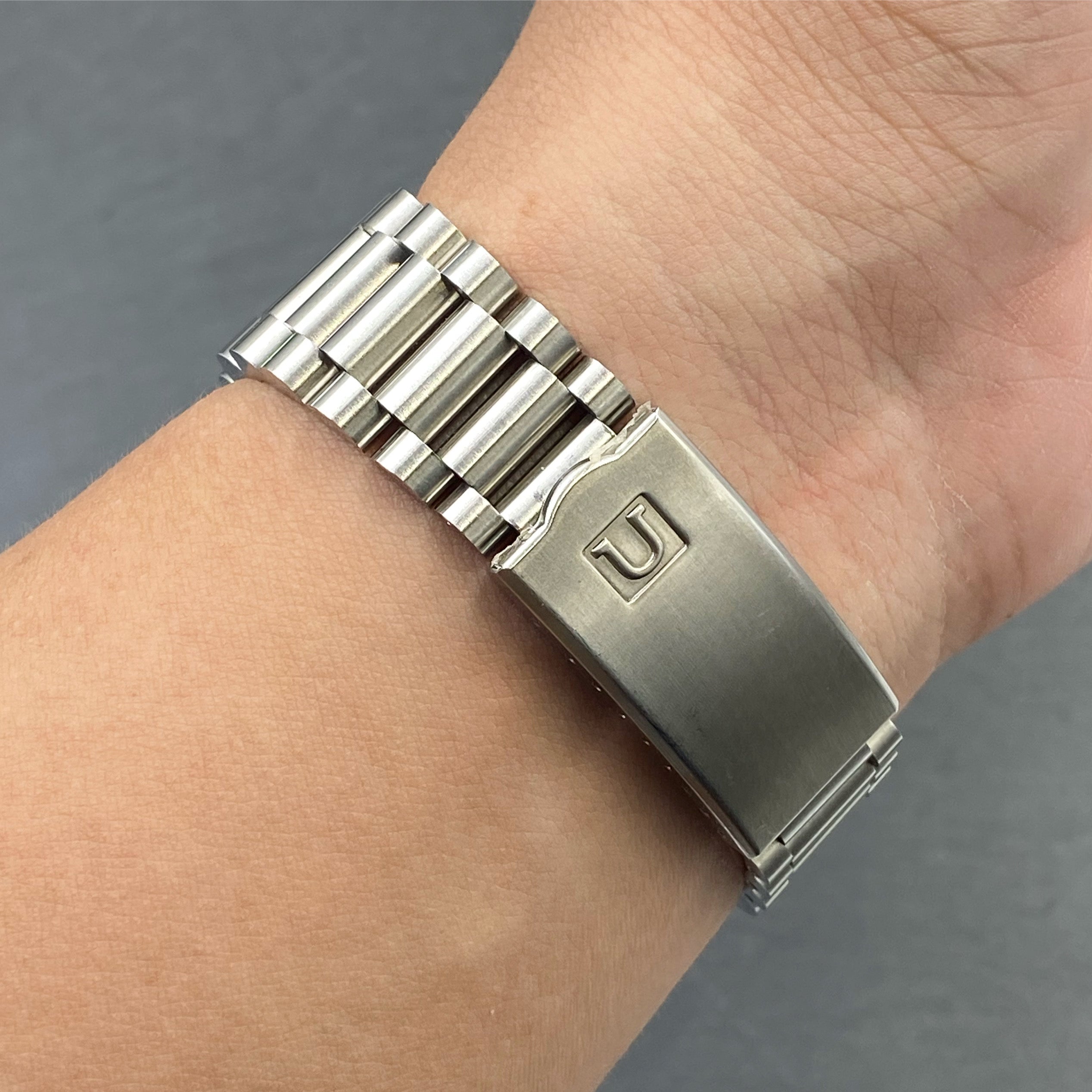Stainless steel bracelet with solid links and deployment clasp worn on wrist, compatible with Tudor Ranger 39 watch