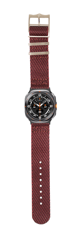 Burgundy fabric military watch strap with black steel case dial and orange accents, featuring textured weave design and metal buckle