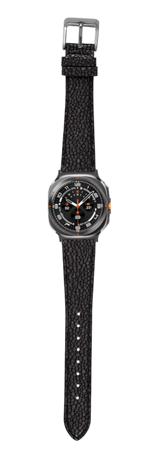 Stingray-textured sports watch with grey titanium case, black dial, orange accents and black fabric strap