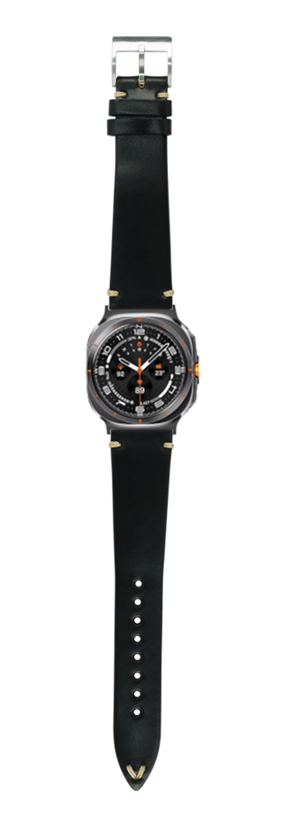 Black leather watch strap with silver buckle and vintage sports watch featuring black dial and orange accents