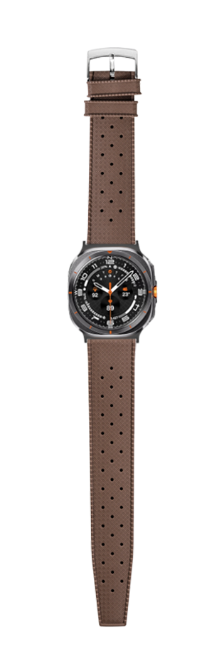 Brown perforated FKM rubber watch strap with gunmetal case and black dial featuring orange accents, displayed full length with silver buckle