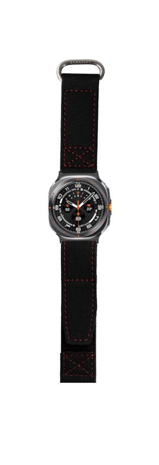 Military style tactical watch with black fabric Velcro strap and red stitching, featuring round dial with orange accents