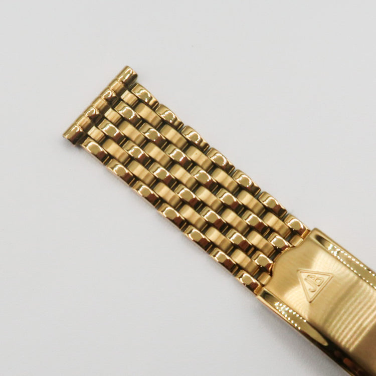 Gold plated seven-row beads of rice watch bracelet with brushed metal clasp on white background