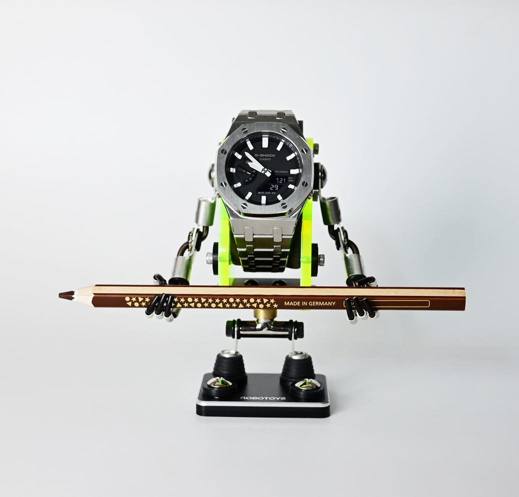 Neon green Minibot watch stand holding stainless steel sports watch with ski poles and black base