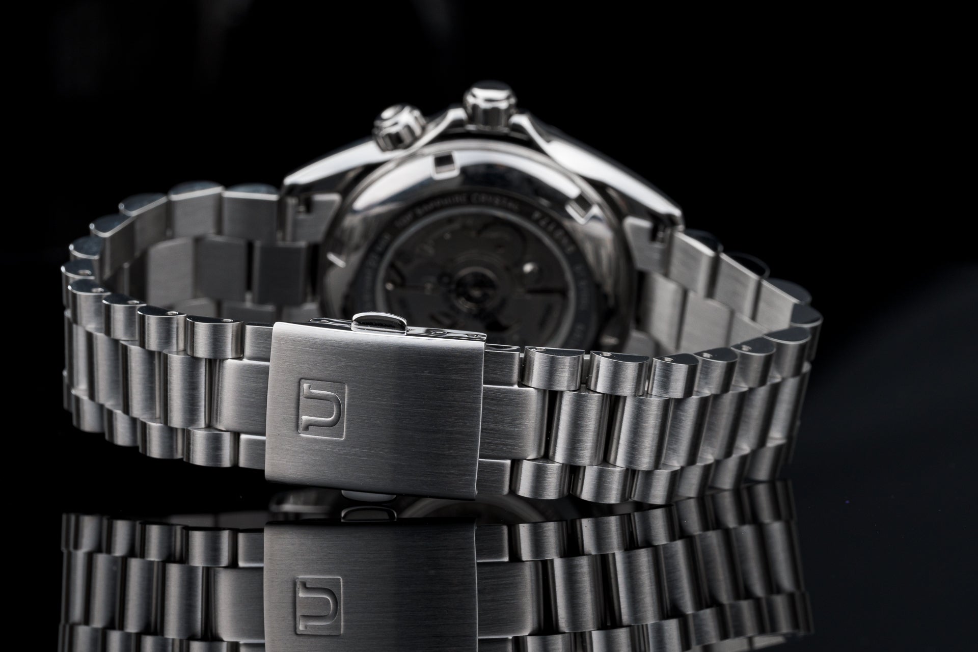 Stainless steel Seiko SARB017 automatic watch with matching metal bracelet and deployment clasp on black background