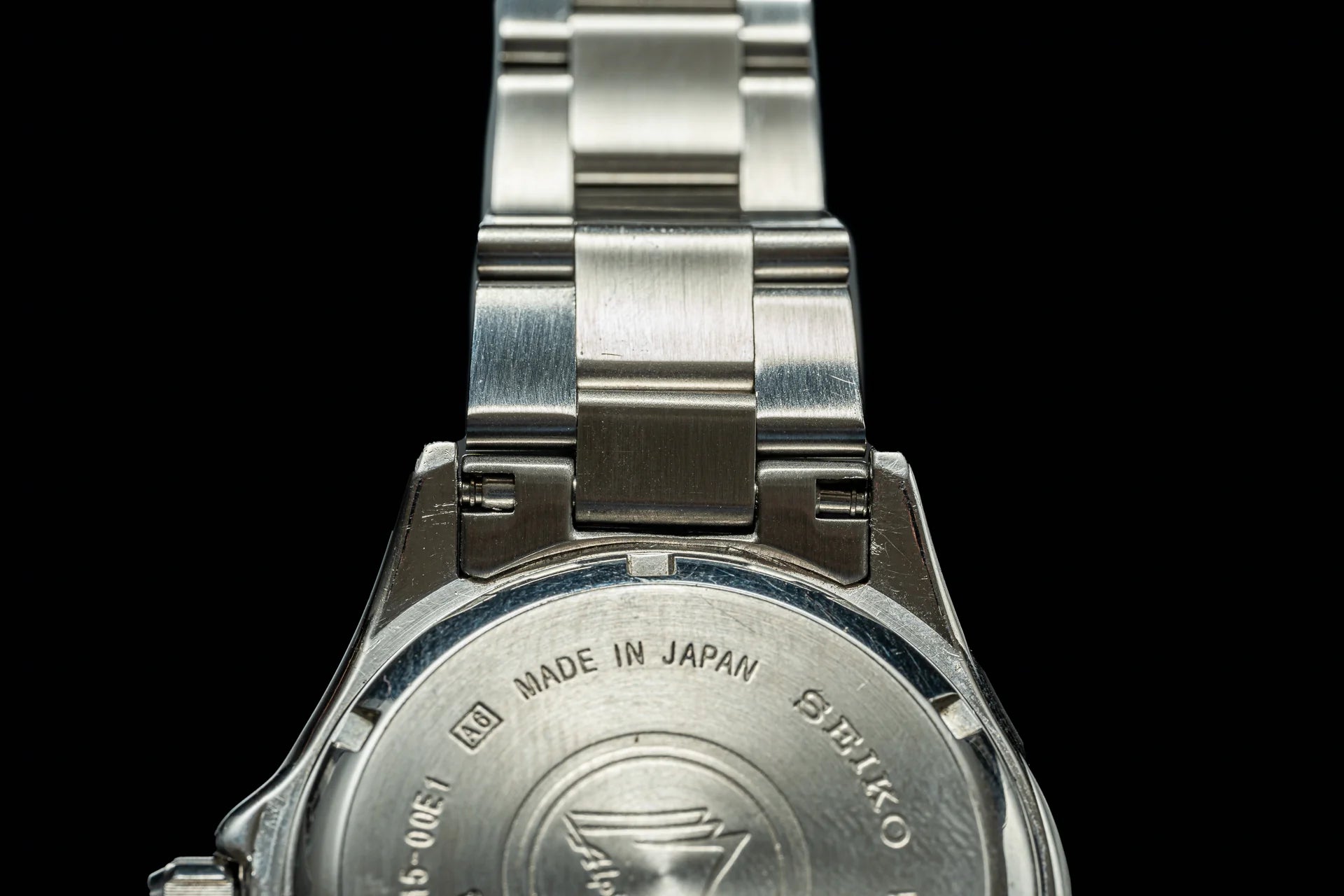 Seiko SARB017 stainless steel watch back case showing Japan origin and Seiko branding with metal bracelet