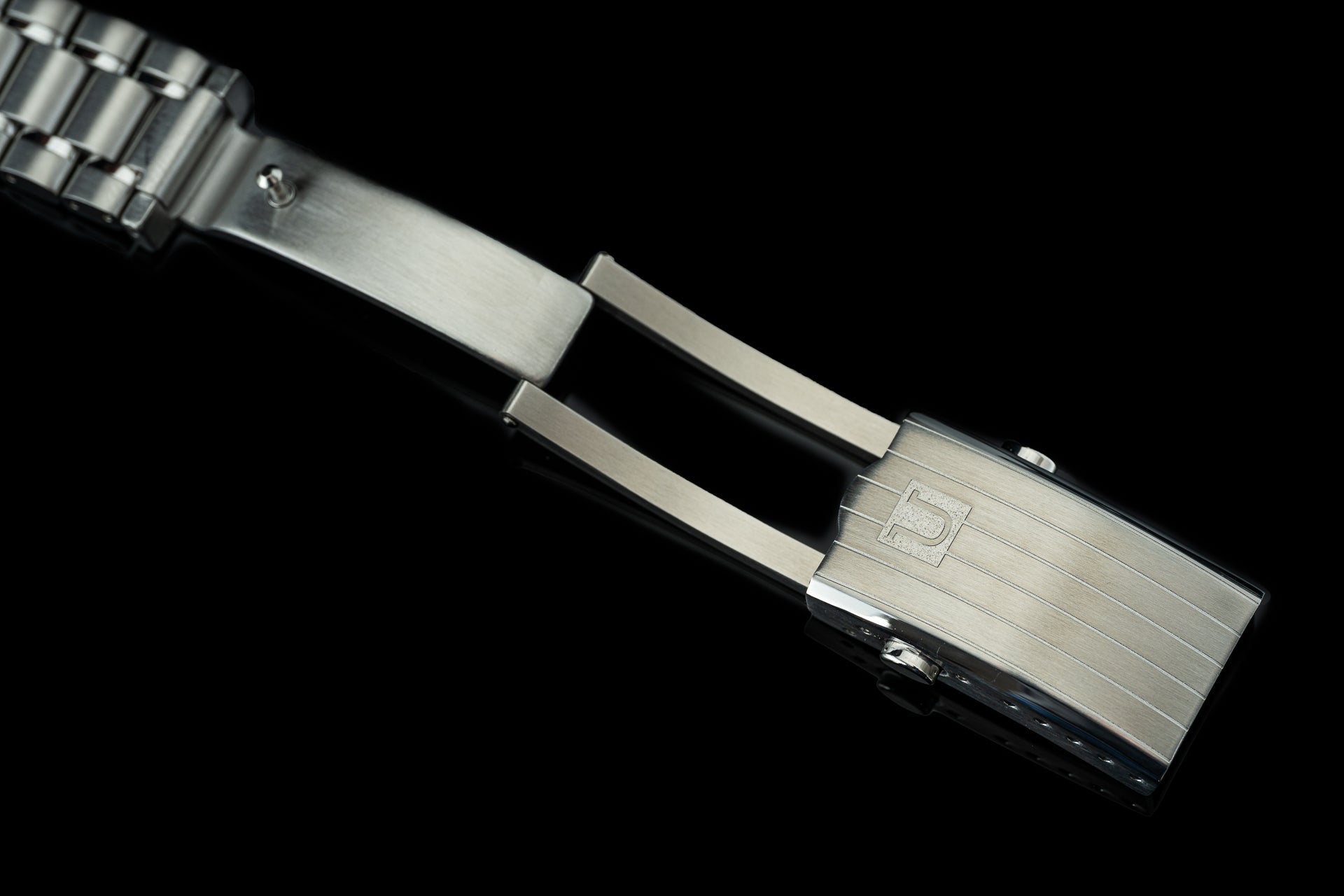 Stainless steel bracelet for Omega Aqua Terra 41mm watch with polished end links and brushed center links on black background