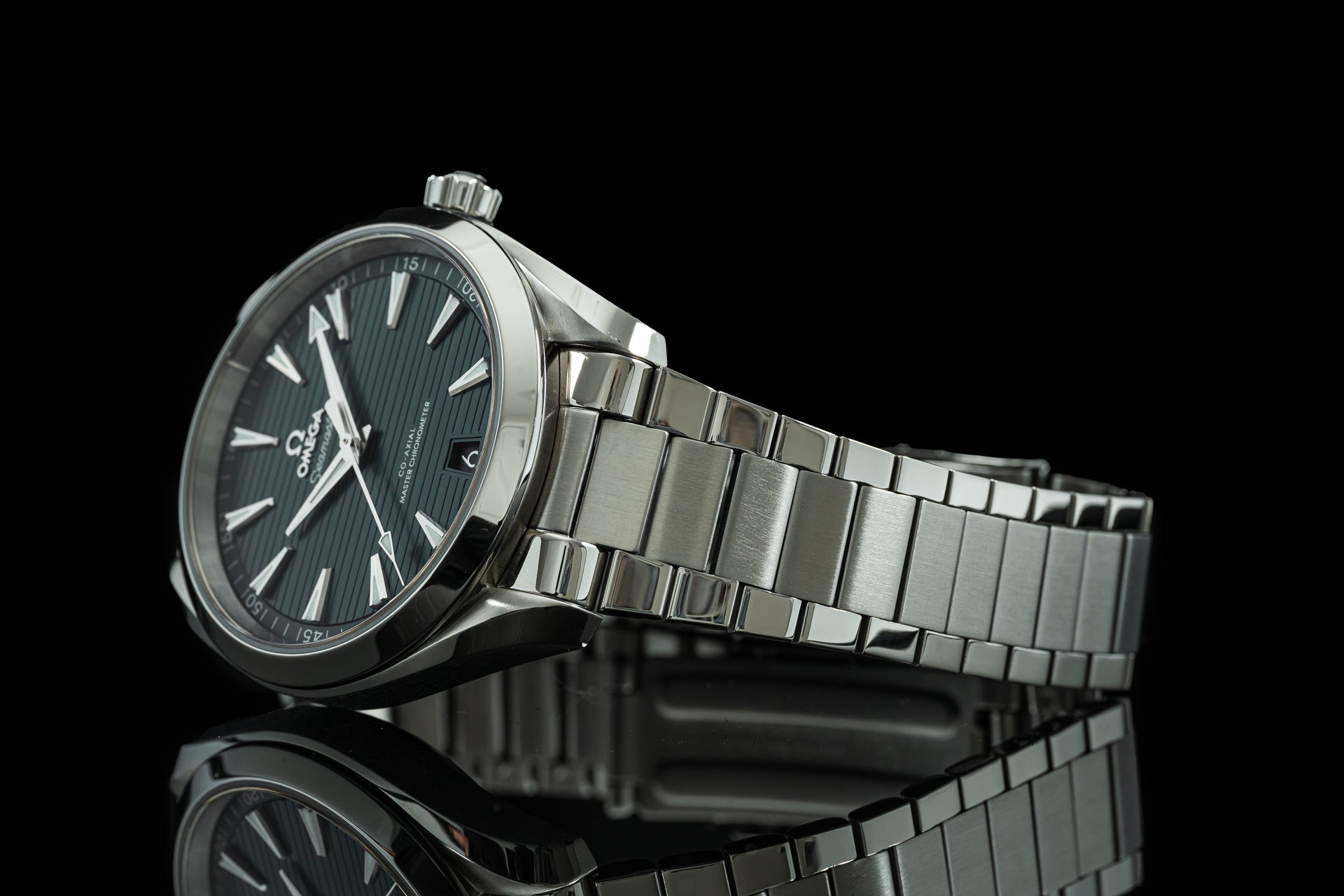 Omega Aqua Terra luxury watch with stainless steel flat link bracelet and black dial on reflective surface