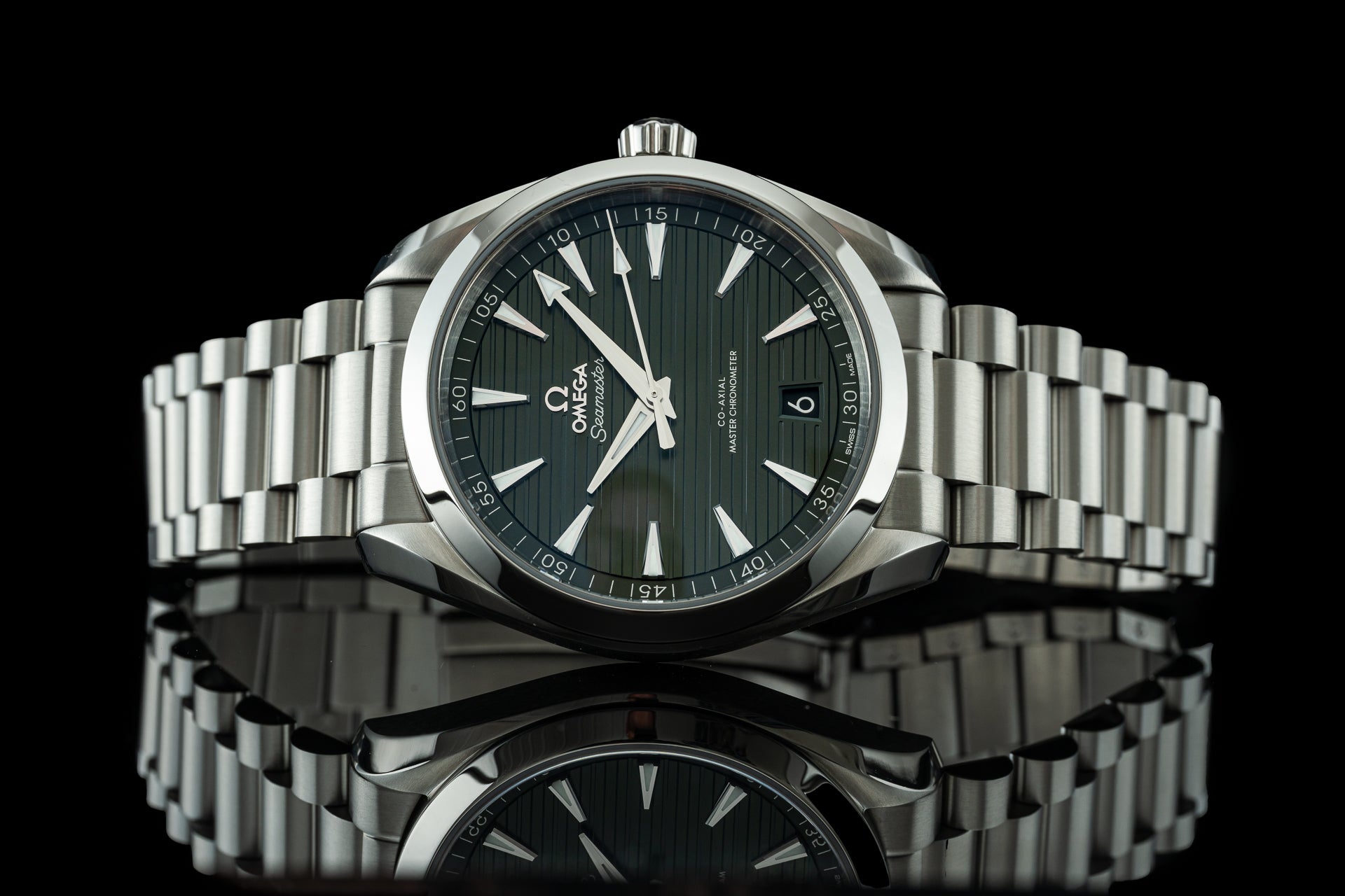 Omega Seamaster Aqua Terra 41mm stainless steel watch with black dial and matching bracelet on reflective surface