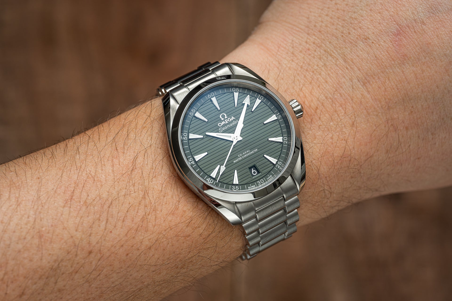 Omega Seamaster Aqua Terra 41mm stainless steel watch with green dial and bracelet on wrist