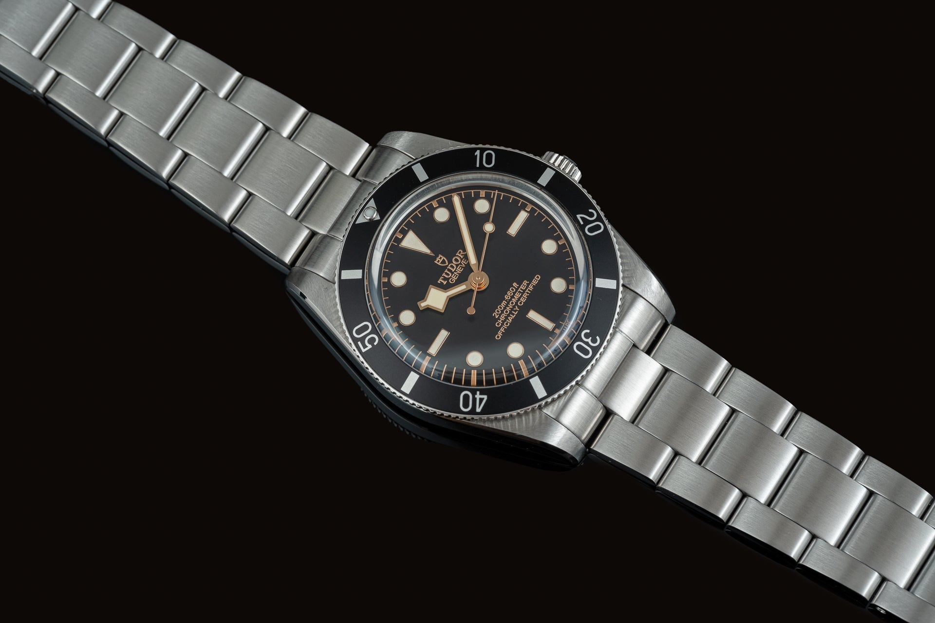 Vintage Tudor Black Bay 54 dive watch with black dial, steel bracelet and rotating bezel on black background