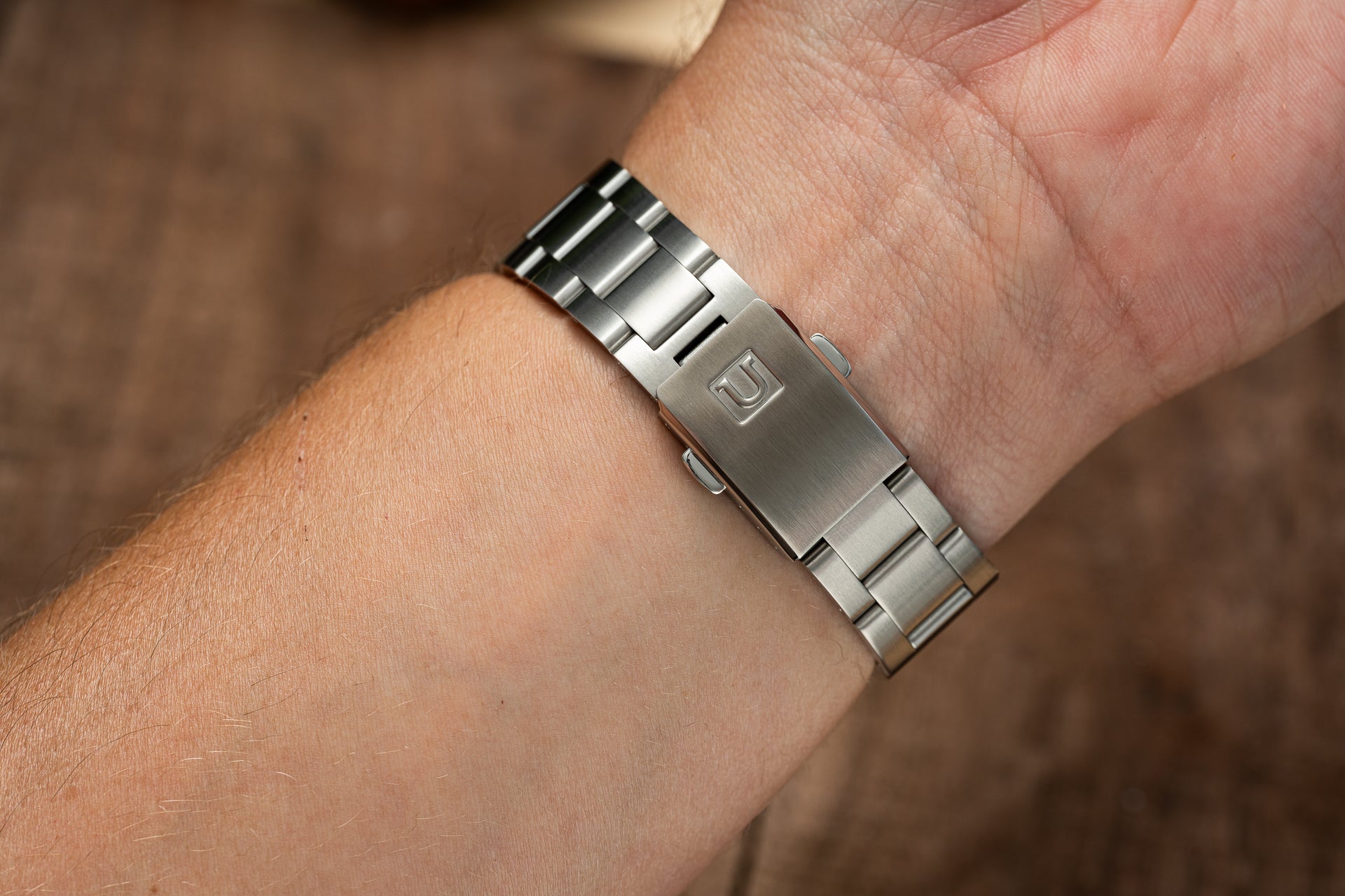 Stainless steel Uncle Senator bracelet with solid links worn on wrist, compatible with Tudor Black Bay 54 watch