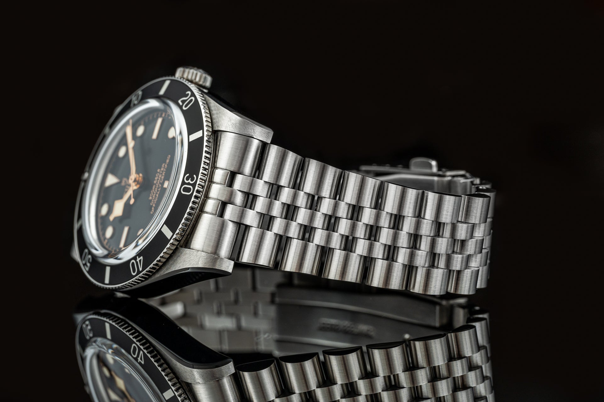 Stainless steel executive bracelet for Tudor Black Bay 54 dive watch with polished and brushed links on black background