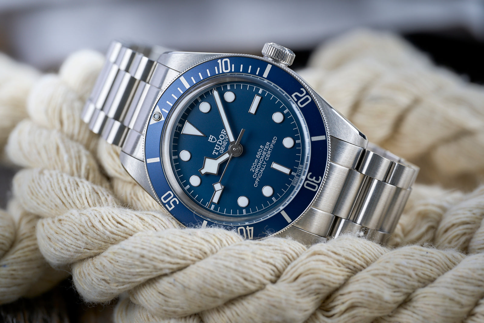 Tudor Black Bay 58 dive watch with blue dial and bezel on stainless steel bracelet displayed on white rope