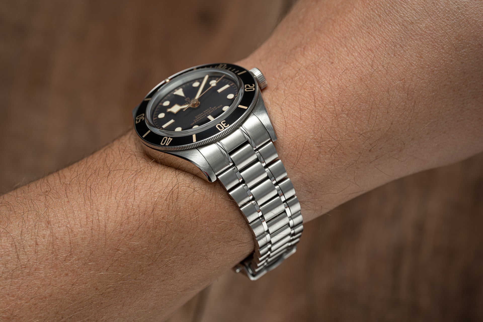 Stainless steel bracelet with three-link design fitted on Tudor Black Bay 58 watch with black dial