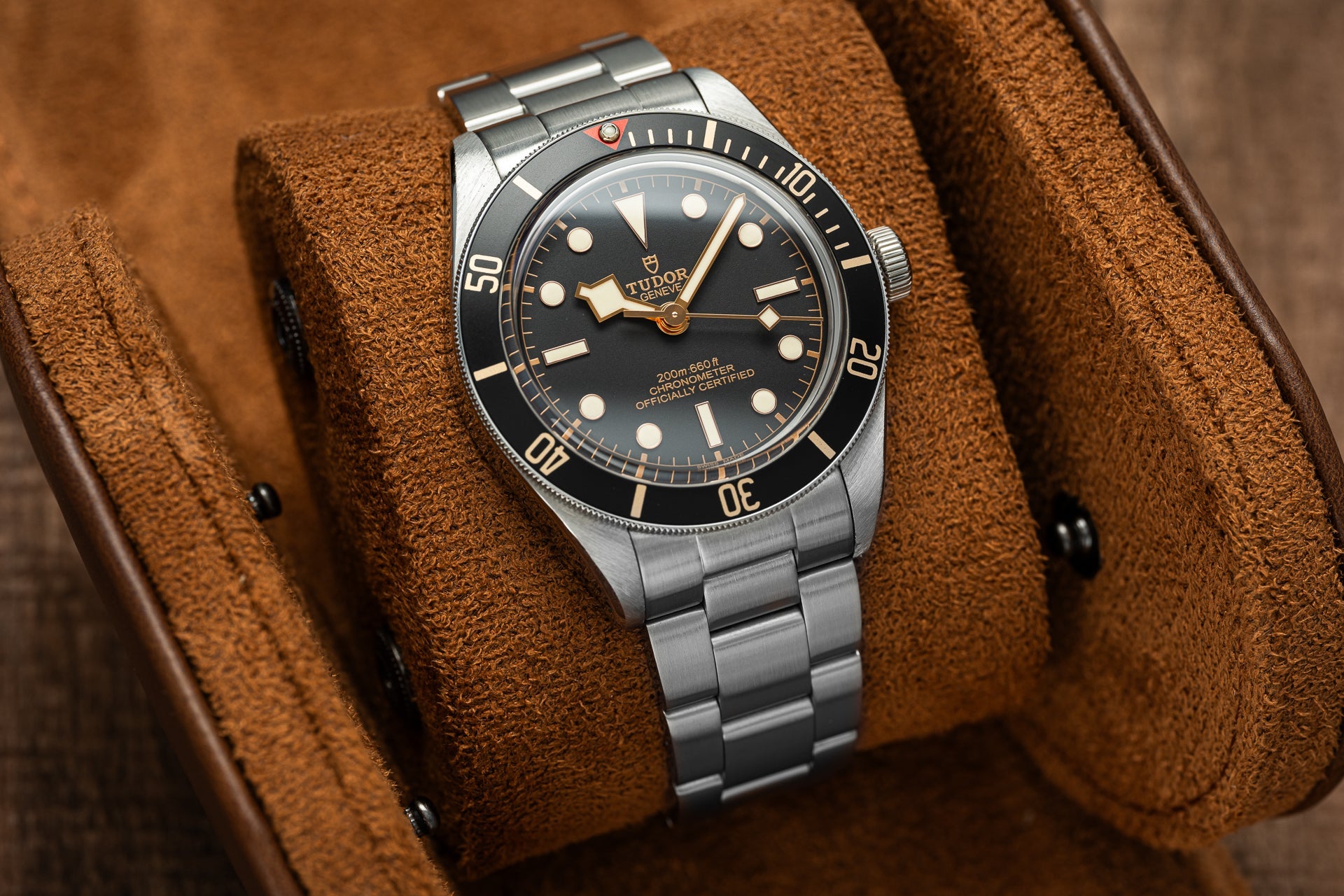 Tudor Black Bay 58 dive watch with stainless steel bracelet and black dial on brown leather strap display