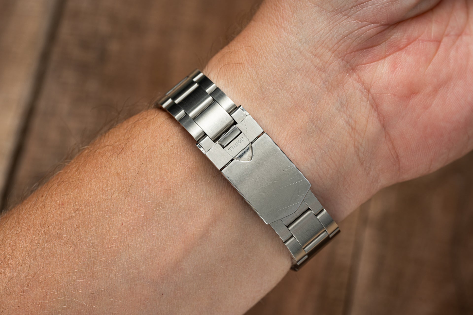 Stainless steel watch bracelet with solid links worn on wrist, compatible with Tudor Black Bay 58 timepiece