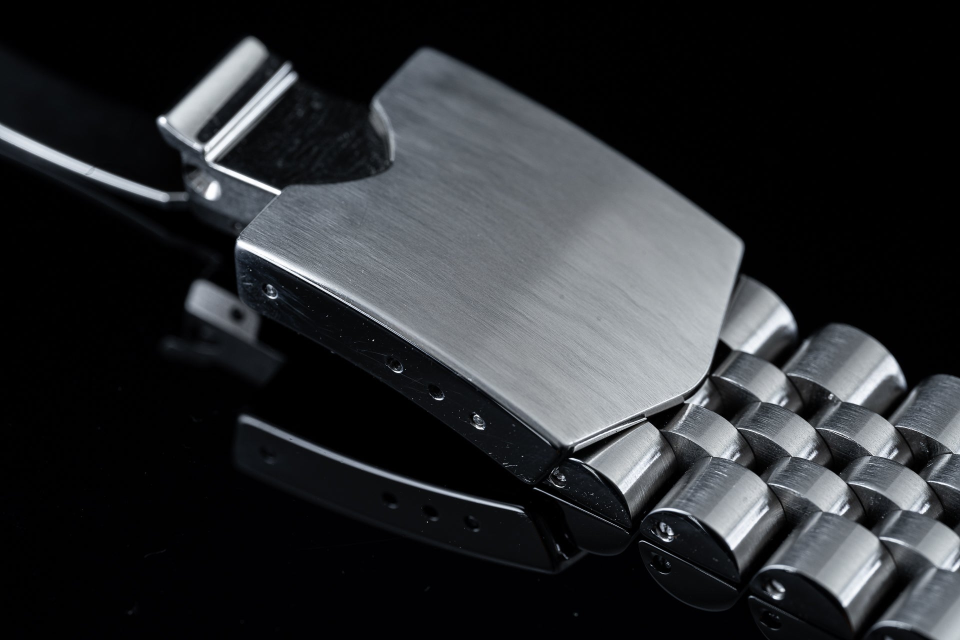 Stainless steel executive bracelet for Tudor 41mm watches with brushed finish and solid metal links on black background
